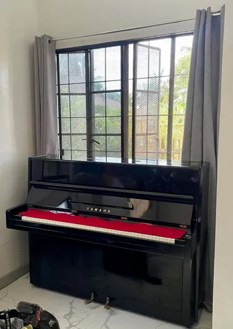 Yamaha upright beside a window