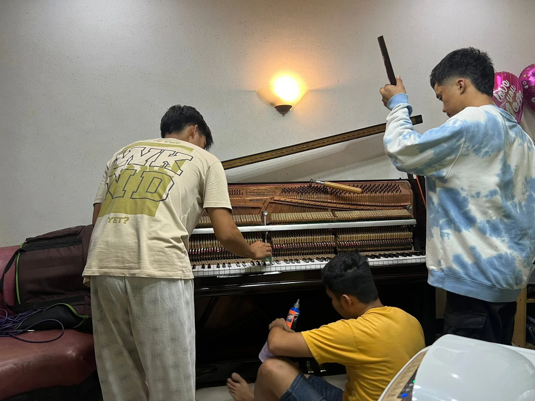 Hands-on work inside an upright piano